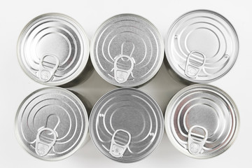 Group of silver canned food on white background.