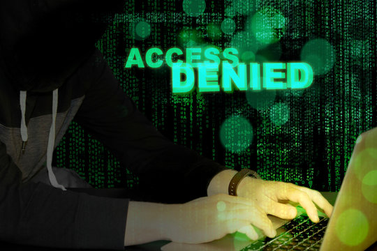 Access denied - hacker and laptop with code background