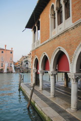 Part of the covered market, market square in Venice, side view, water and hand sculpture