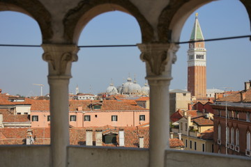 Venice, Italy. View from the tower of the palace of Contarini del Bovolo, selected focus: columns of arches in defocus, buildings and towers in focus