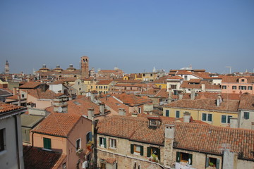 Fototapeta na wymiar View of Venice from the tower of the Palace of Contarini del Bovolo. The tiled roofs of the houses in which the inhabitants of Venice live
