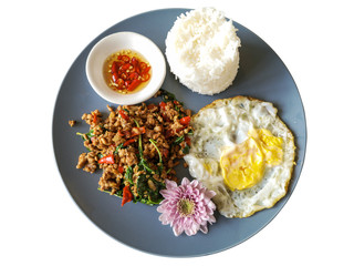 Spicy Thai food rice topped stir-fried pork and basil with Fried egg in gray dish isolate white background with clipping path.