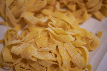 Raw tagliatelle pasta on a tray