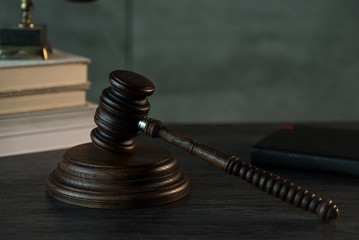 Law and Justice, judge gavel with scales on wooden table with blurred background.