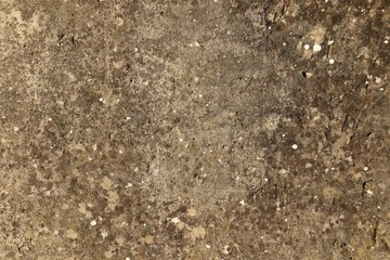 Spotty rough concrete surface with a non-uniform brown color.