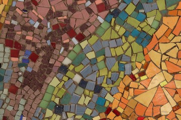 surface covered with mosaics of various shapes, colors green, blue, orange, yellow, red
