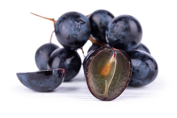 sliced dark grapes on white surface close-up