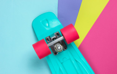 Plastic mini cruiser board on colored background. Pastel color trend. Summer fun. Youth minimalistic concept. Top view