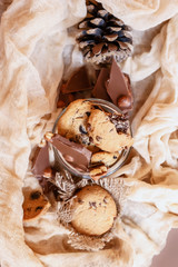 Shortbread chocolate cookies and a glass of milk on a brown background.  Milk chocolate with nuts and cookies.