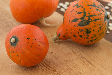 Three orange pumpkins on the board. Close-up