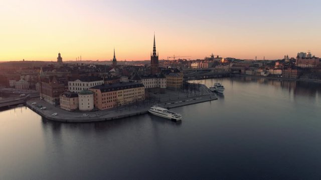 Aerial view of Stockholm skyline cityscape at sunrise. Drone shot flying over water, Riddarholmen island city buildings and church. Gamla stan, Old Town landmark, Capital of Sweden