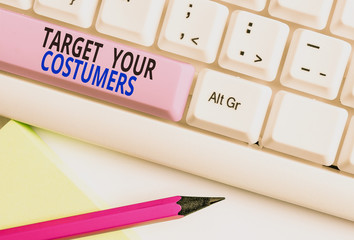 Text sign showing Target Your Costumers. Business photo showcasing Specific Range and Interest Potential Users and Buyers White pc keyboard with empty note paper above white background key copy space