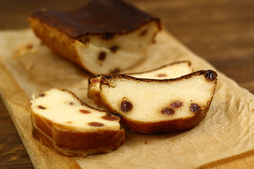 Slice of curd pudding on cutting board