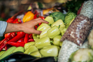 Buying vegetables at farmer's market, close-up.