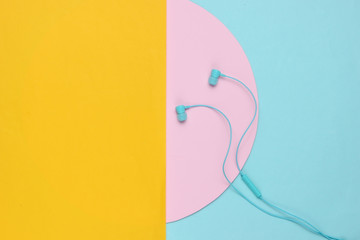 Wired earphones on colored background. Music lover. Top view