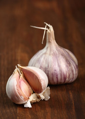 Garlic bulbs on wooden table, split.