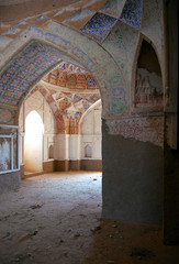 A reconstructed but empty mosque at Takht-e-Pul between Balkh and Mazar-i-Sharif in Balkh Province, northern Afghanistan. Interior view showing details of the architecture and painted walls.