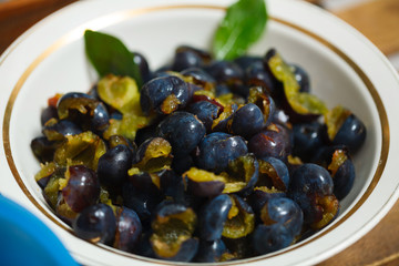 peeled plums for jam in a white plate