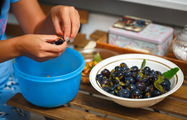 girl peels plums to make homemade jam