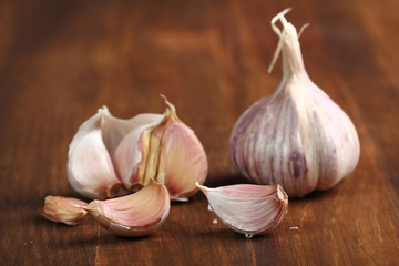 Garlic bulbs and cloves on wooden table