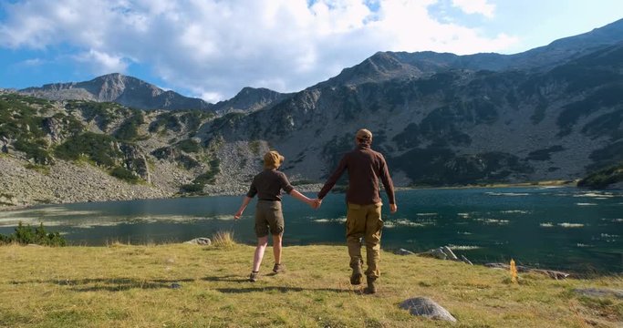 Couple of travelers walk and having fun in the bulgarian mountains, summer time hiking 