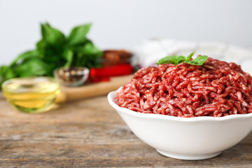 Fresh raw minced meat on wooden table, space for text
