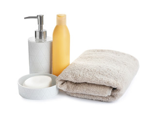 Obraz na płótnie Canvas Folded soft towel and toiletries on white background