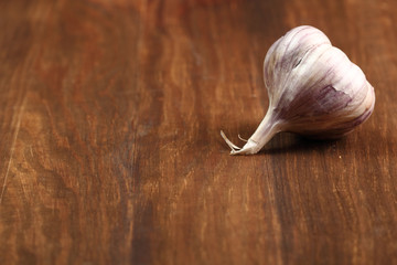 Garlic bulb on wooden table. Copy Space.