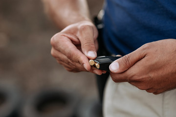 Reloading the weapon, copy space, close-up.