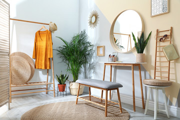 Stylish room interior with little table and comfortable bench