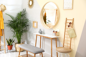 Stylish room interior with little table and comfortable bench