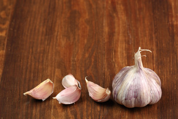 Garlic bulbs and cloves on wooden table, copy space.