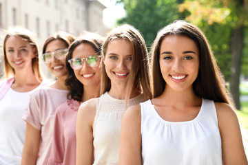Happy women posing outdoors on sunny day. Girl power concept