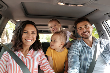 Happy family in car on road trip