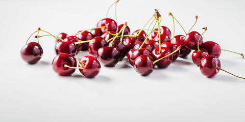 Naklejka na ściany i meble Fresh cherries with water droplets. 2 or more cherries on the table.