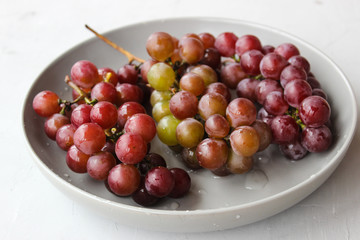 grapes on a plate with water droplets