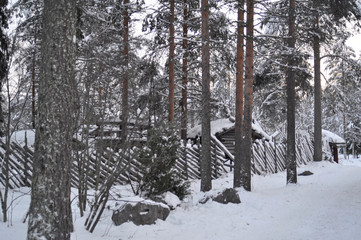 Snow covered Old wooden house in Santa Claus Village in Rovaniemi. Arctic circle, Lapland, Finland