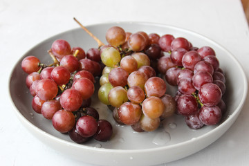 grapes on a plate with water droplets
