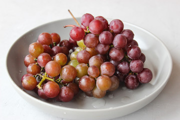 grapes on a plate with water droplets