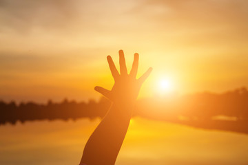 Hand of Young Woman Enjoying Nature with sunrise.