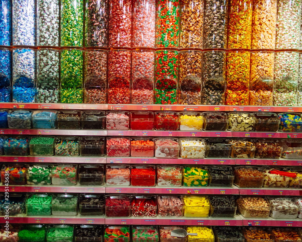 Wall mural colorful candy store shelves with variety of flavors