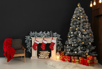 Stylish Christmas interior with decorated fir tree and fireplace