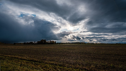 storm clouds over asphalt road in perspective