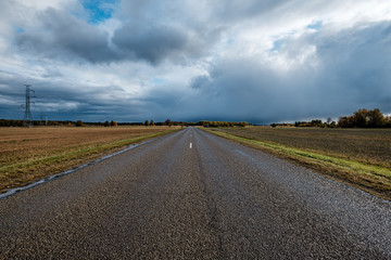 storm clouds over asphalt road in perspective