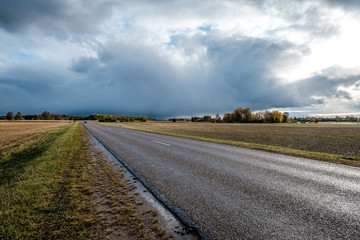 storm clouds over asphalt road in perspective
