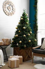 Stylish interior with decorated Christmas tree in living room