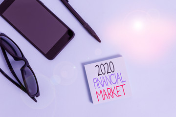 Handwriting text writing 2020 Financial Market. Conceptual photo place where trading of equities, bonds, currencies Eyeglasses colored sticky note smartphone cell pen cool pastel background