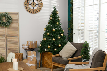 Beautiful decorated Christmas tree in living room interior