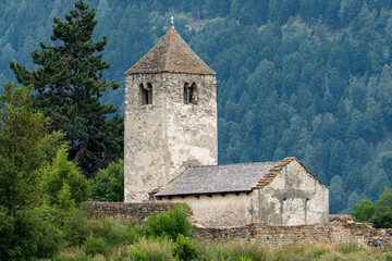 Fototapeta na wymiar Old chapel St. Sisinius in Laas on a cloudy day in summer