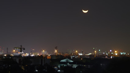 Moon set in city.